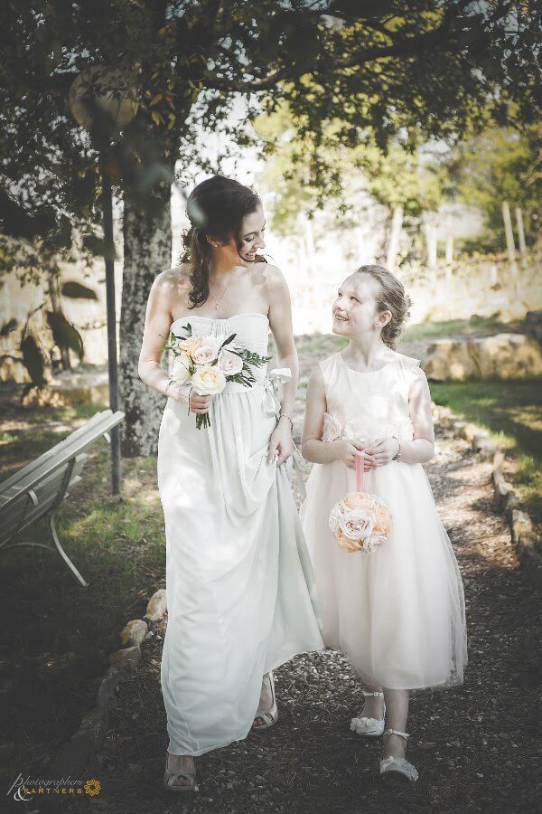 Bridesmaid and baby reach the bride