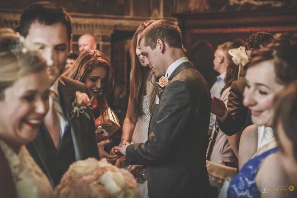 guests congratulate the groom