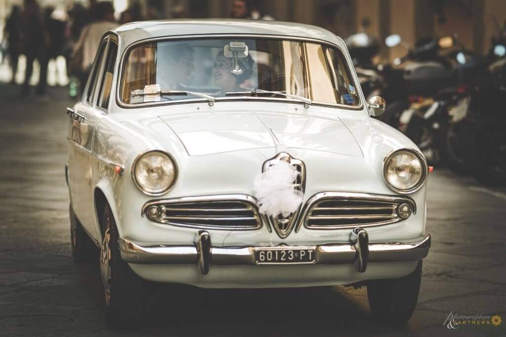 Emma & Alex an italian car to reach the reception location