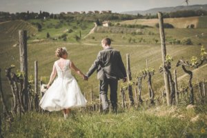 Emma & Alex walk through the vineyards in the Chianti hills