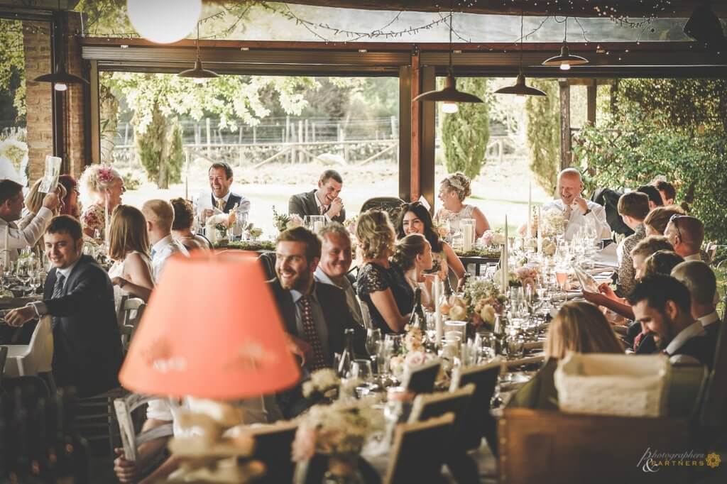 The newlyweds and their guests enjoy the wedding dinner