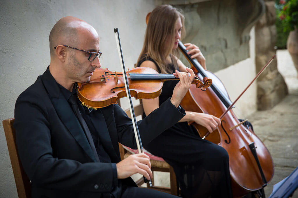 a string duo play during the reception