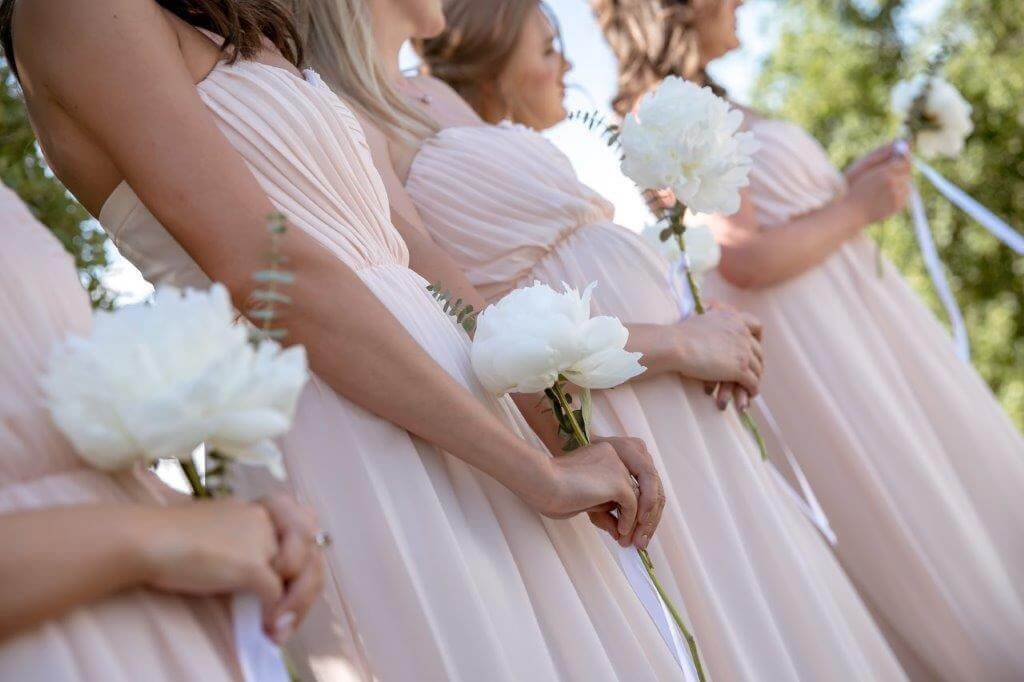 The bridesmaids attend the ceremony