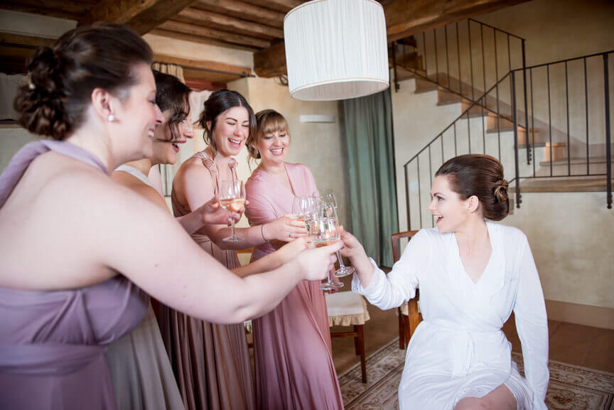 The bride cheers with the bridesmaids