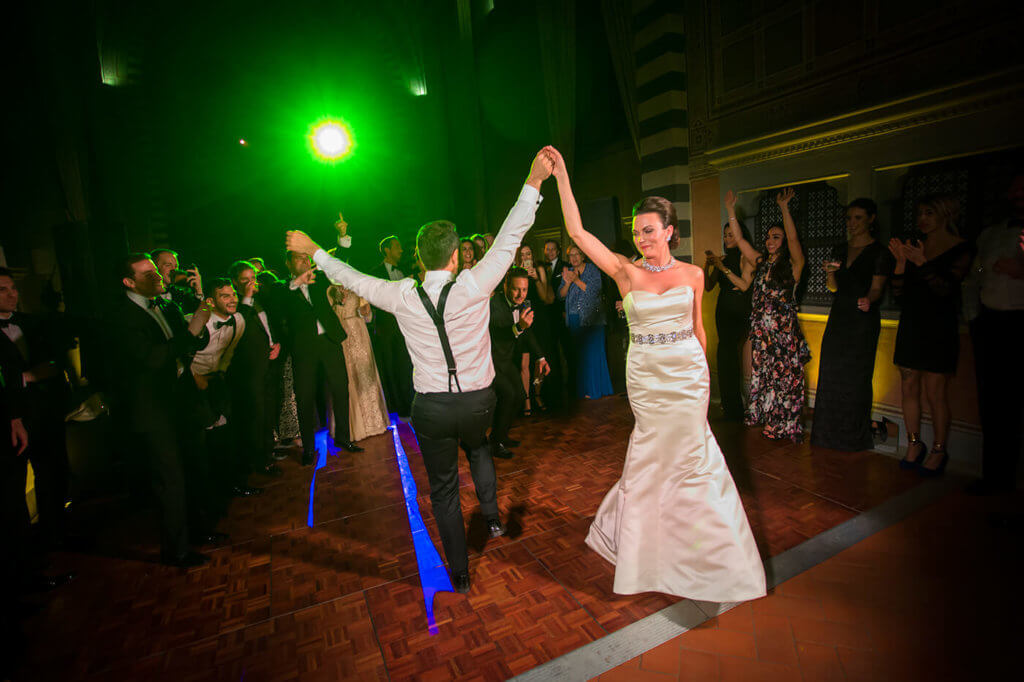 Bride and groom have a dance party in the old convent room