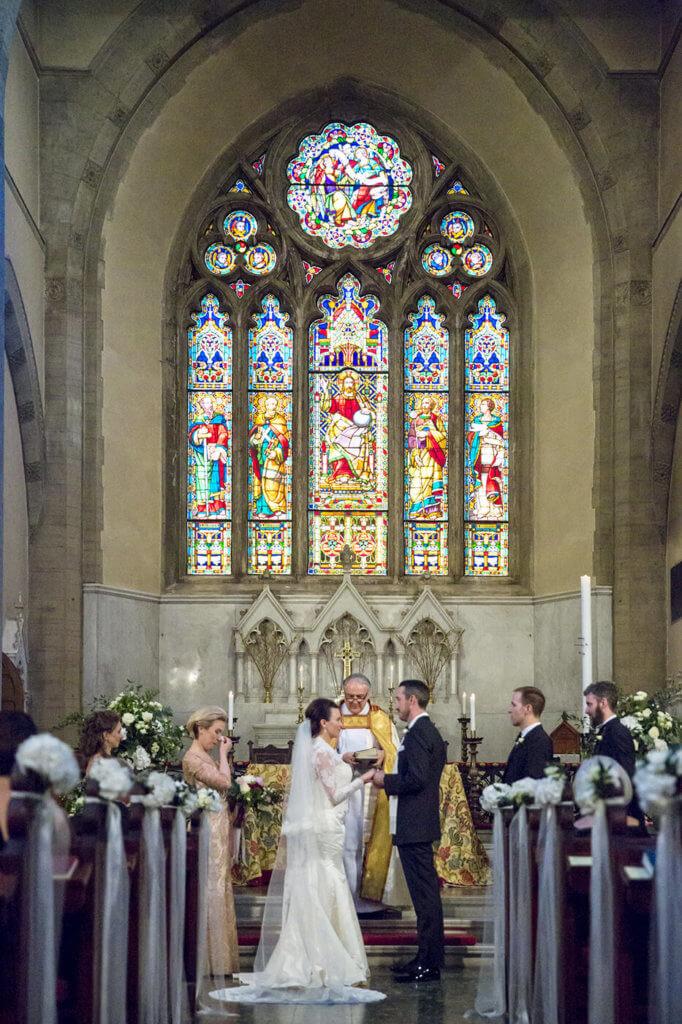 Bride and groom at wedding ceremony exchanging rings