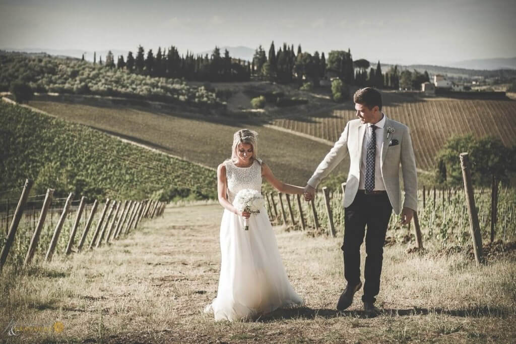 Emma & Edward walk through the vineyard