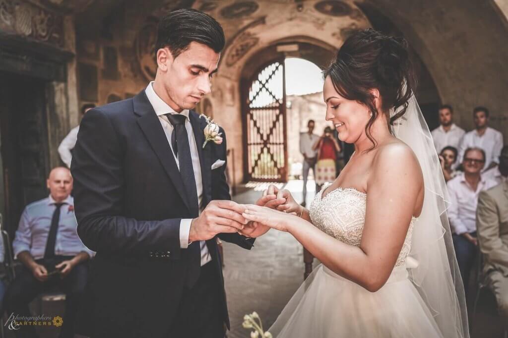 The bride and groom exchange rings