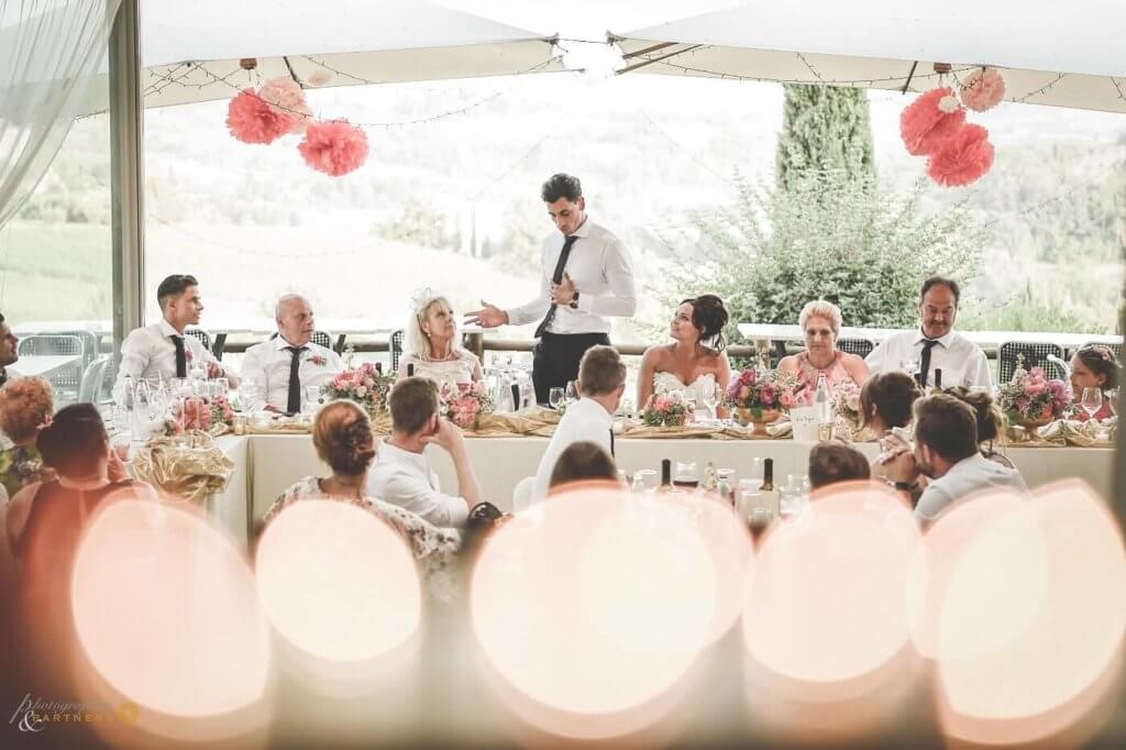 The groom reads a speech for the bride and the guests during the reception