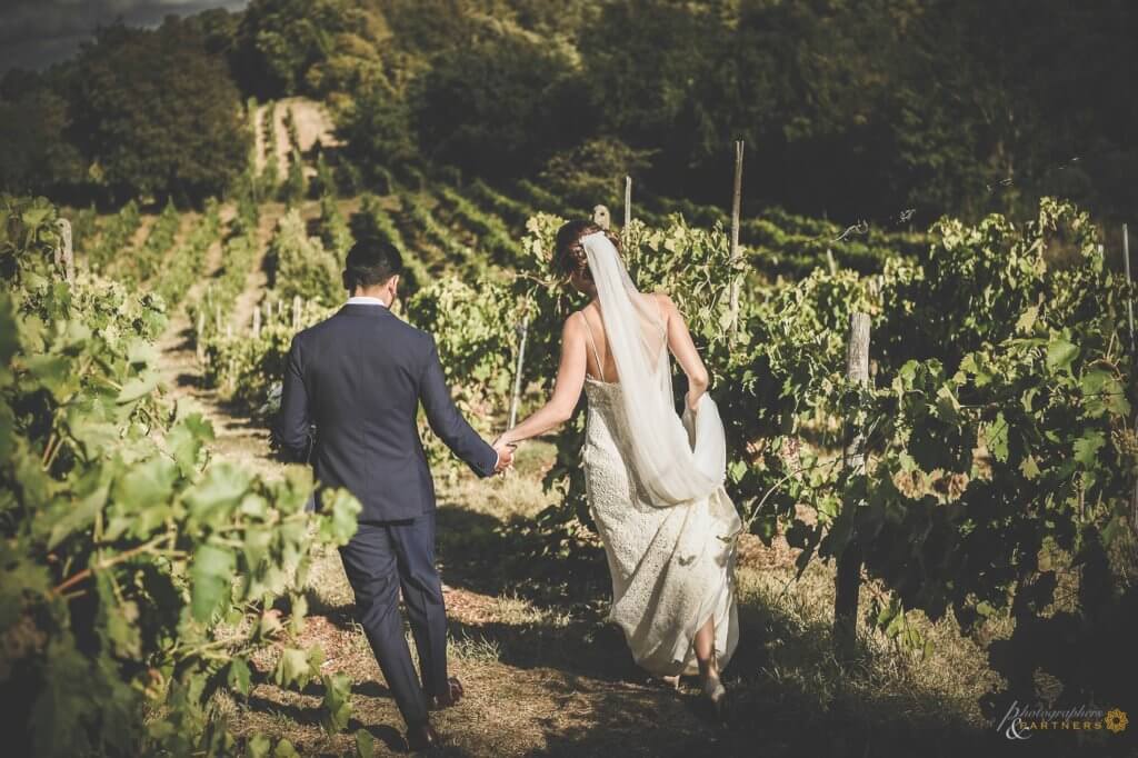 Sarah & Brett walk through the vineyard