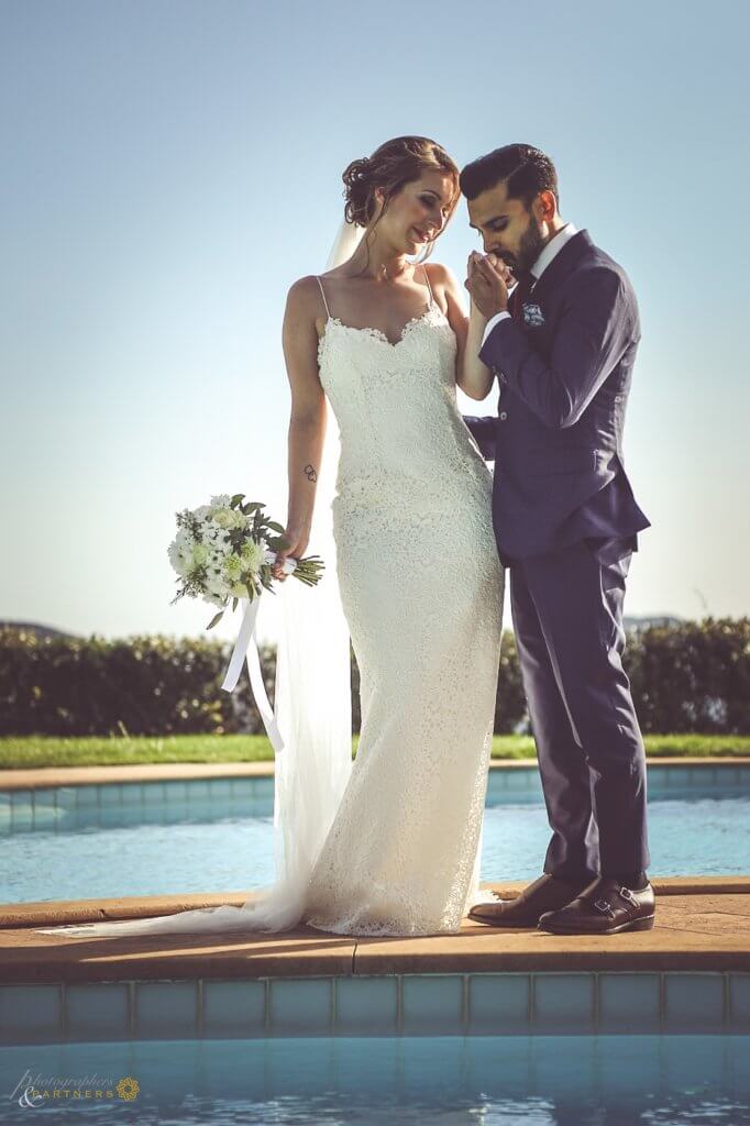 Sarah & Brett kiss in front of the pool