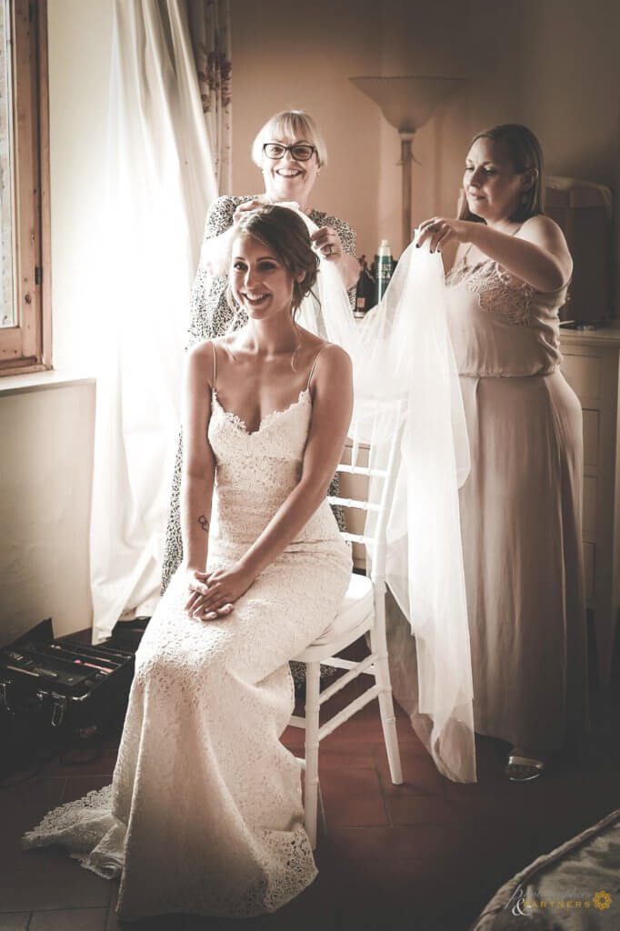 The bride prepares for the ceremony with her bridesmaids