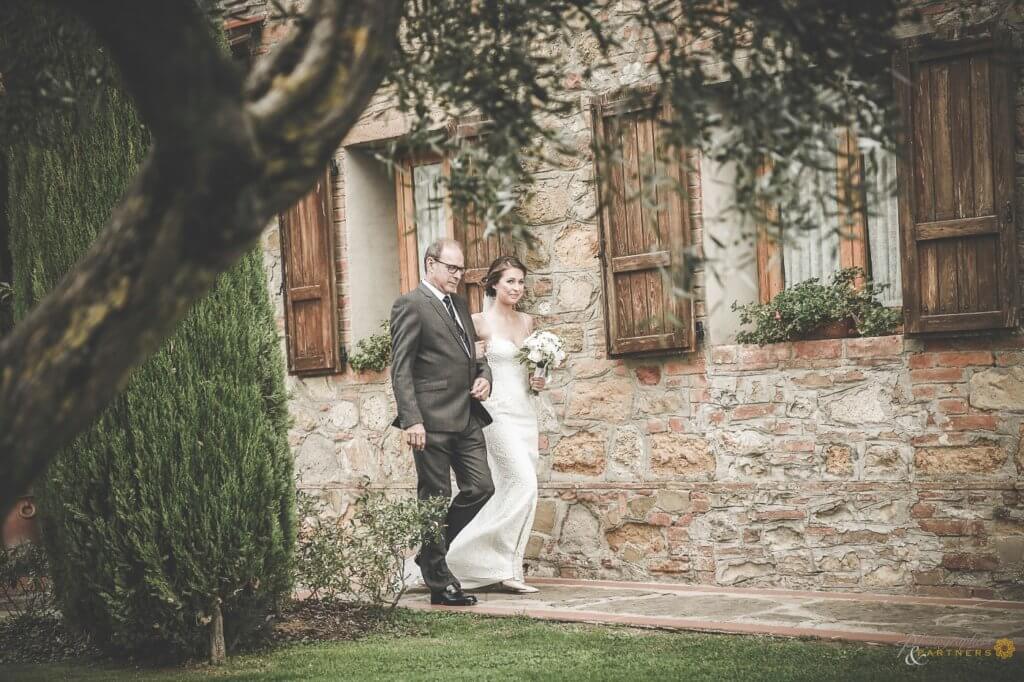 The bride arrives to the location of the ceremony with her father