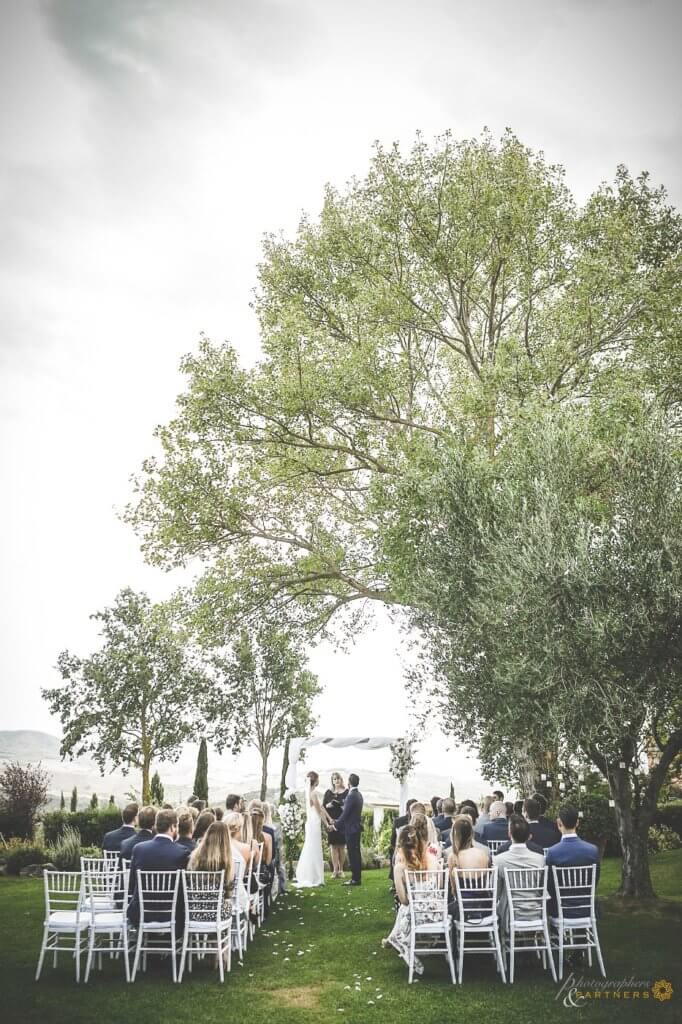 Bride and groom at wedding ceremony listen to registrar speech