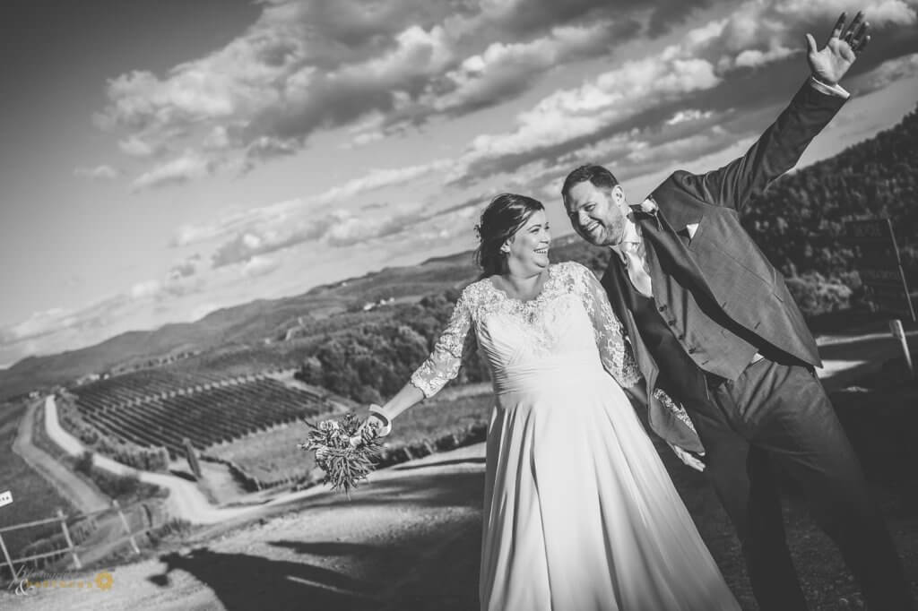 Bride and groom have fun in the vineyard