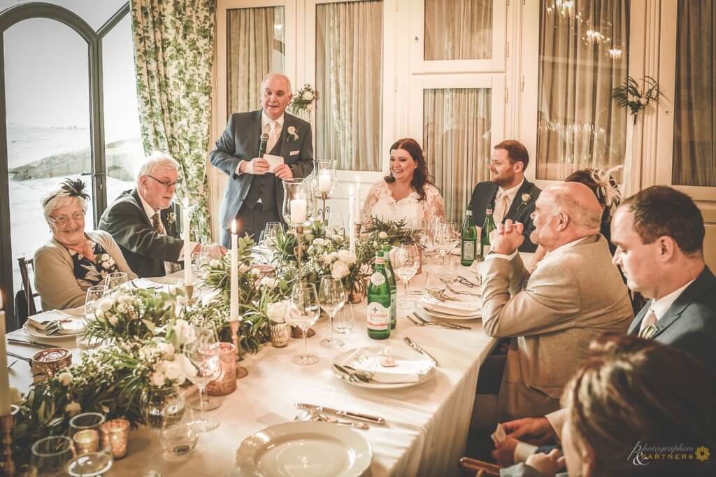 The bride's father reads a speech for the guests