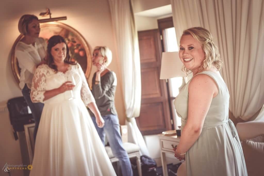 The bride prepares for the ceremony with her bridesmaids