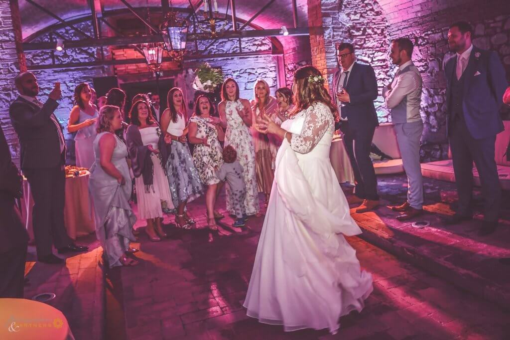 Bride dancing in the historical wine cellar