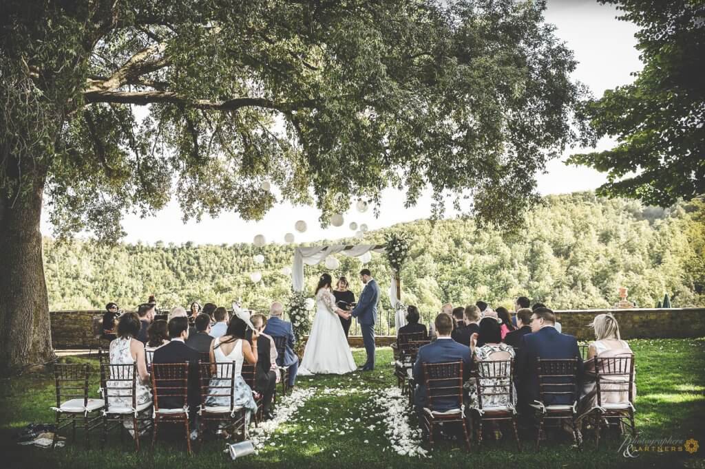 Bride and groom hold hands at wedding ceremony