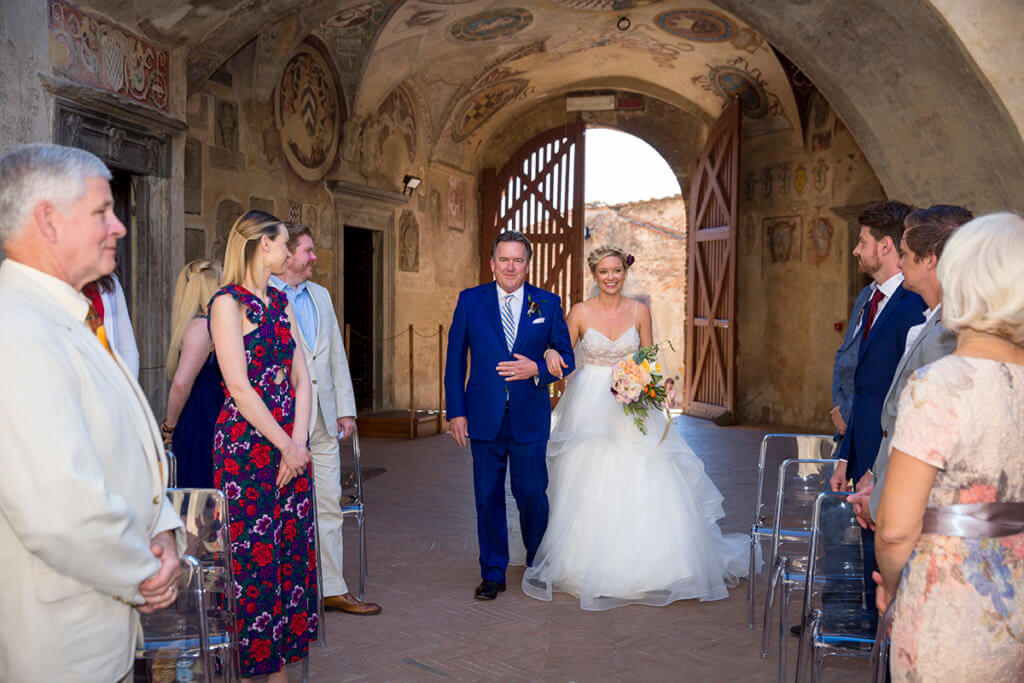 The bride arrives to the location of the ceremony with her father