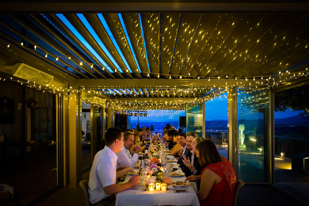 The newlyweds and guests enjoy wedding dinner