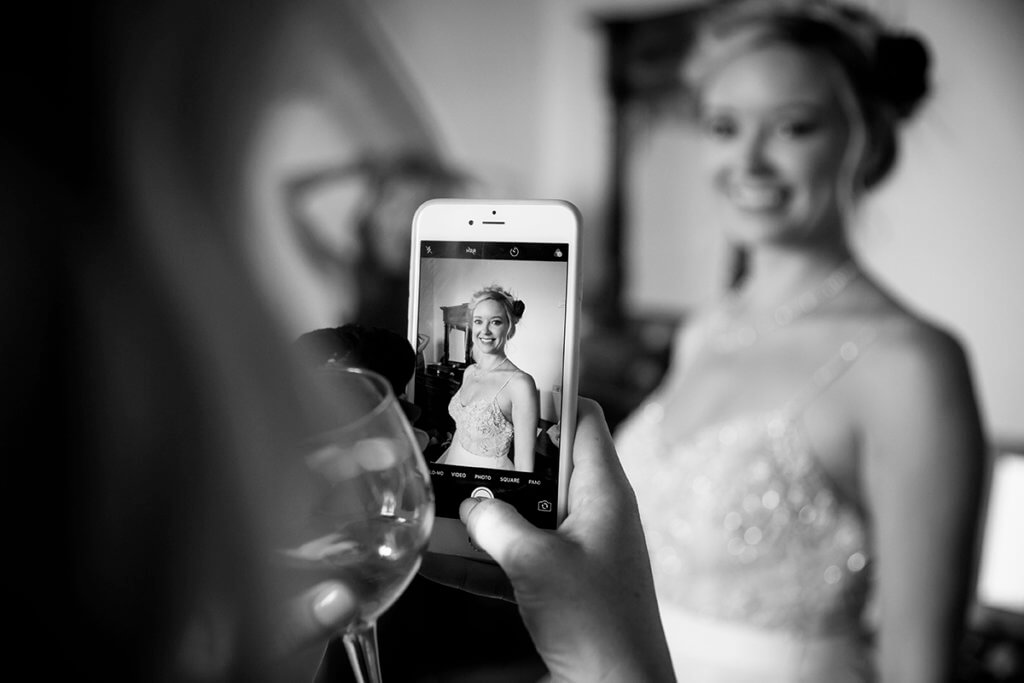 the bride's sister snaps a photo to the bride