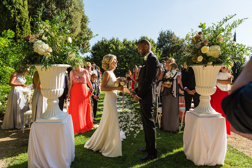 Bride and groom hold hands at wedding ceremony