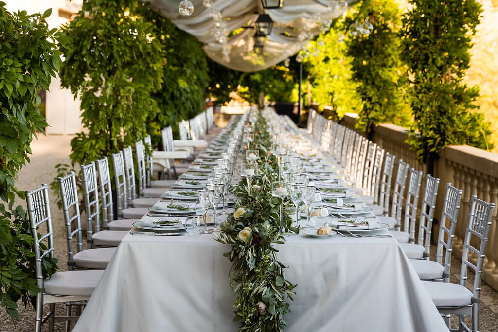 A long table is prepared for the wedding dinner