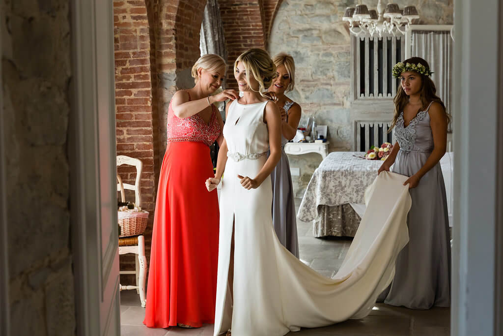 The bride prepares for the ceremony with her bridesmaids