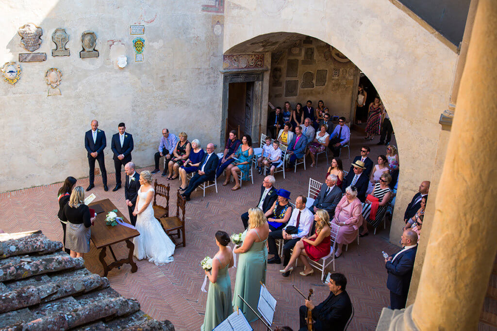 Bride and groom listen to registrar during the wedding ceremony