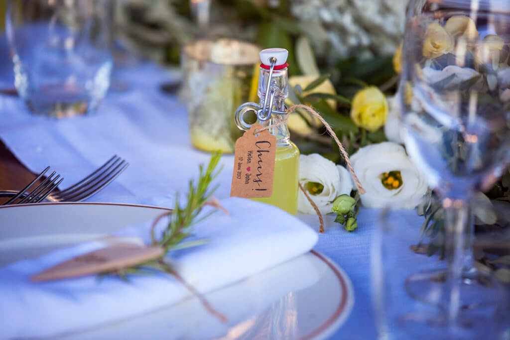 the newlyweds offer a limoncello bottle to the guests