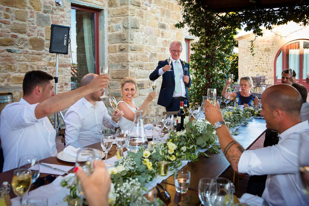 The bride's father reads a speech for the guests