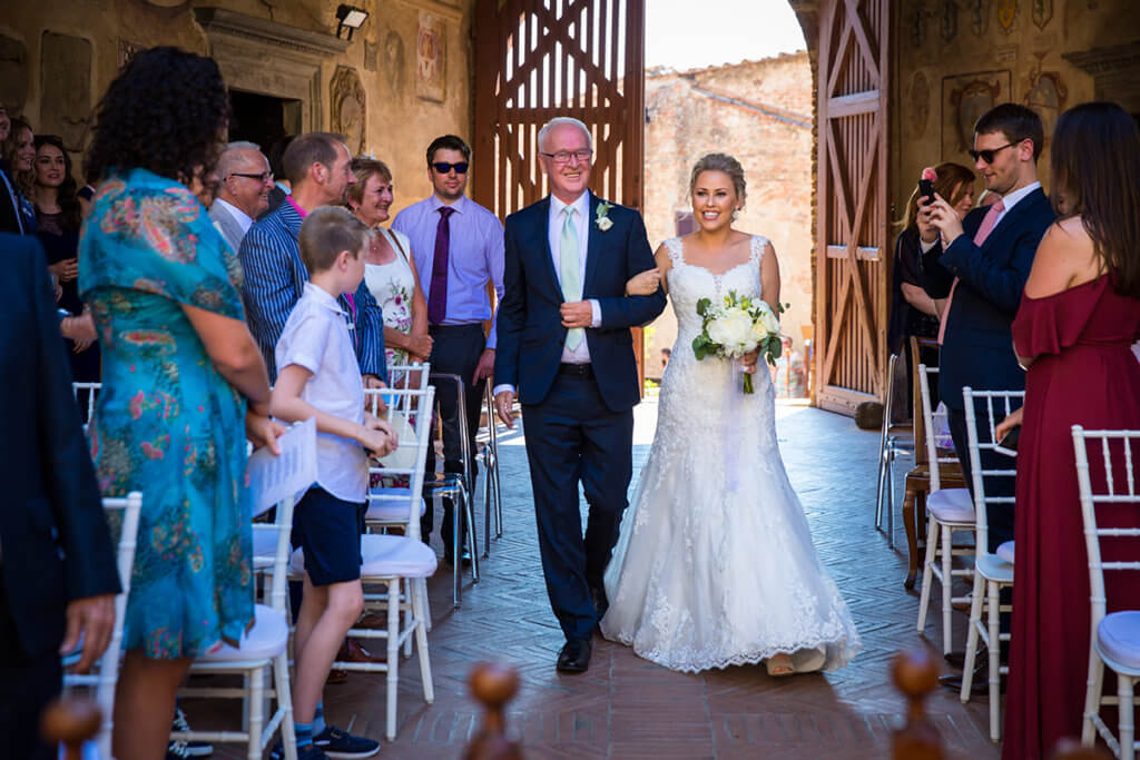 The bride arrives to the location of the ceremony with her father