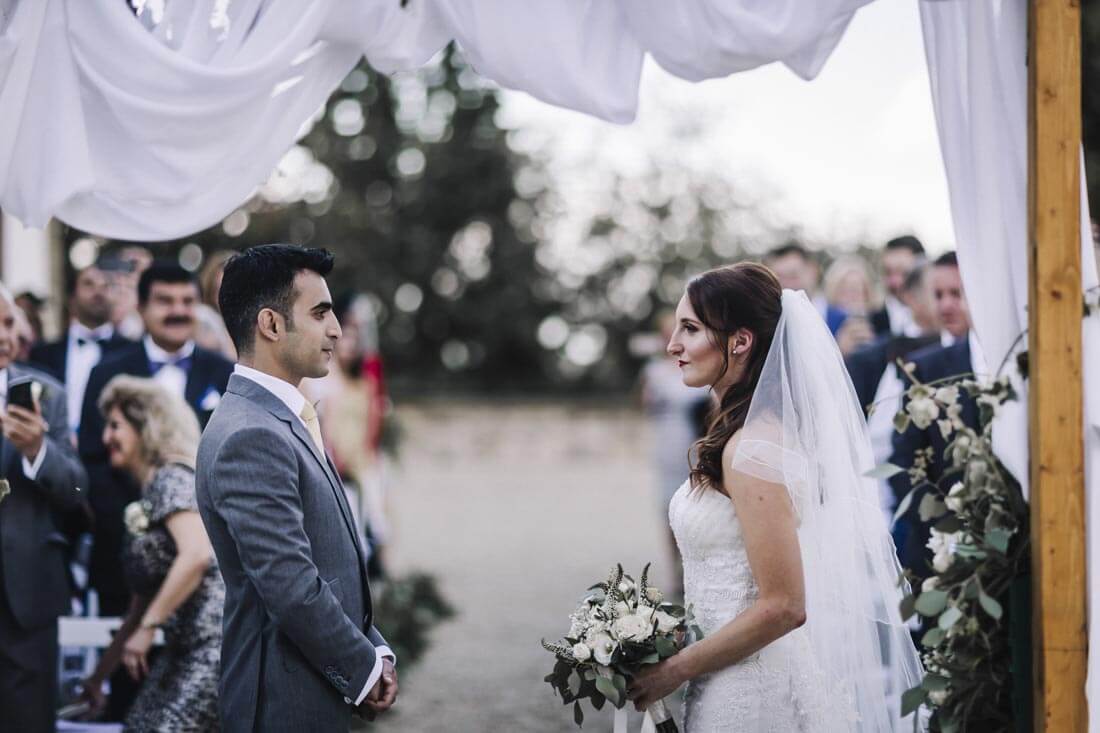 Bride and groom look at each other during the ceremonies