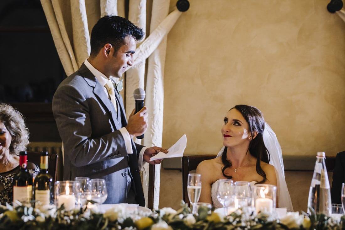 The groom reads a speech for the bride and the guests