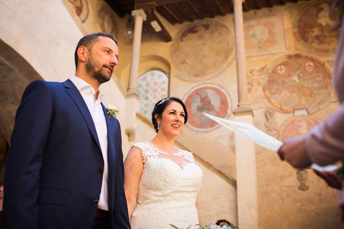 Bride and groom hold hands during the wedding ceremony