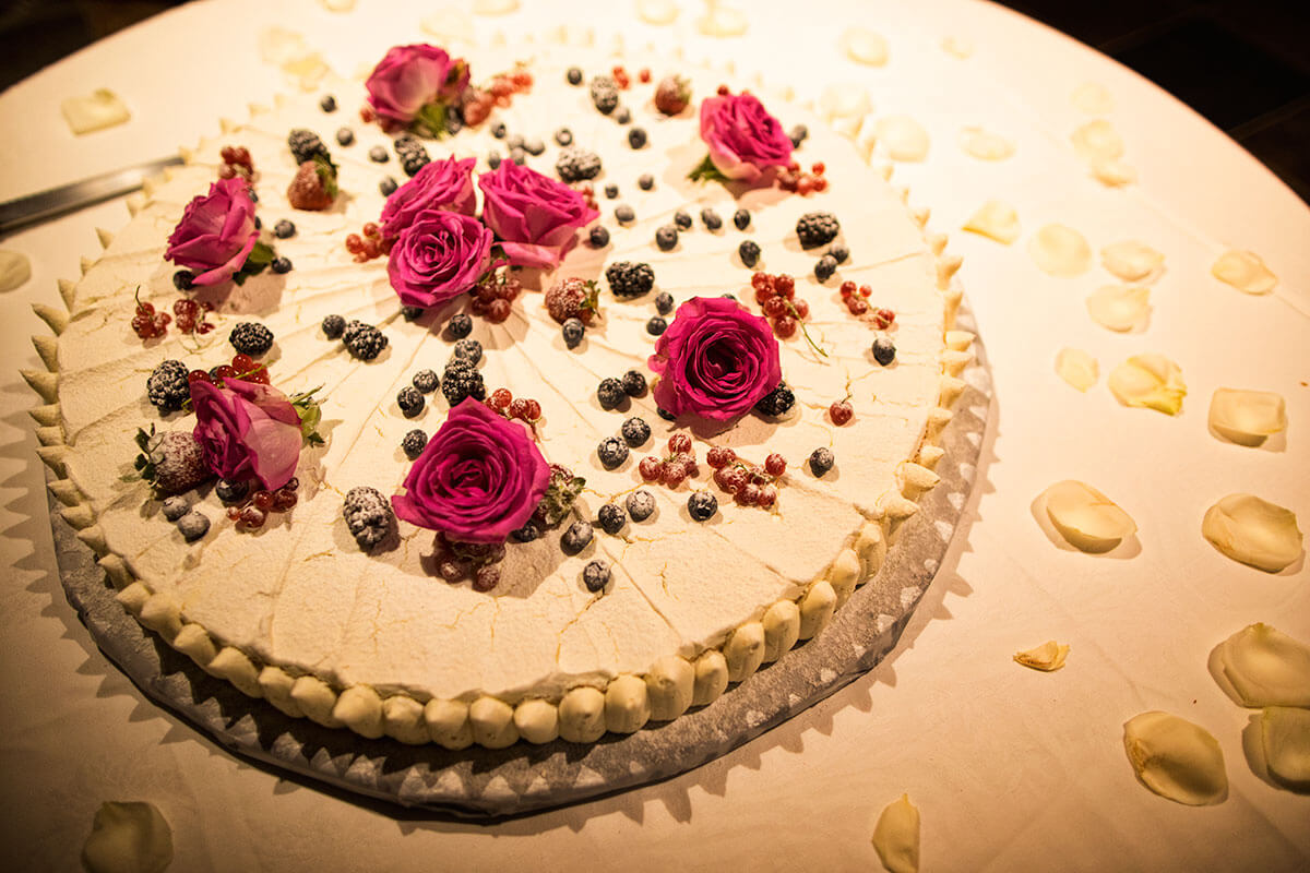 The newlyweds and their guests are ready for the wedding cake