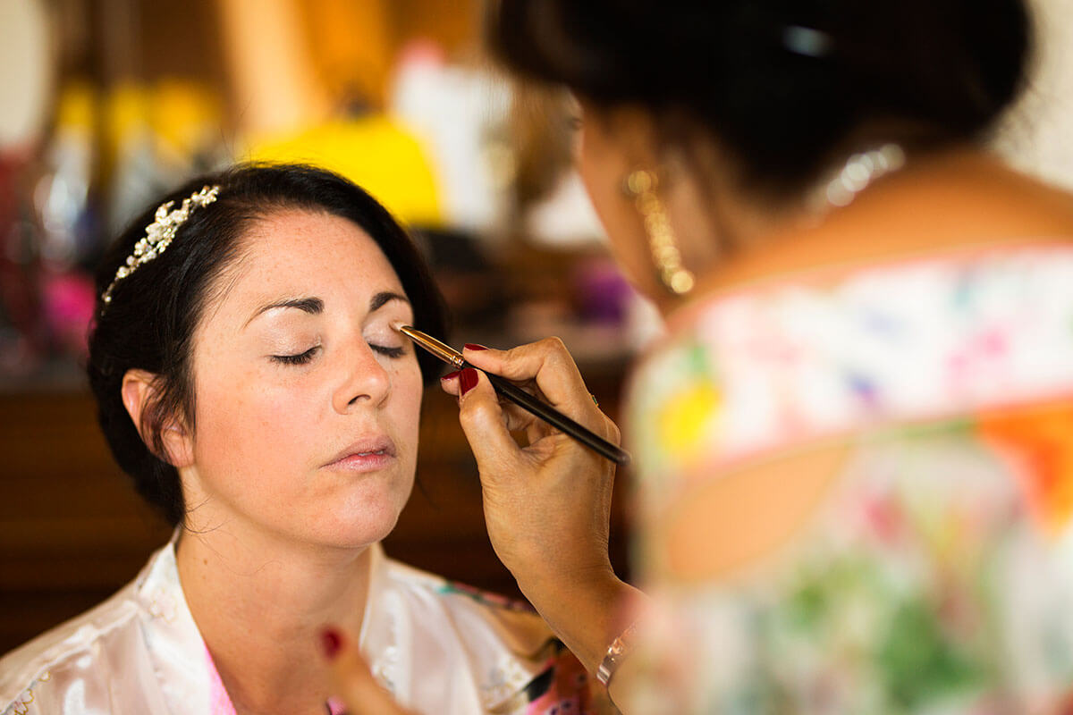 A make-up artist make up the bride